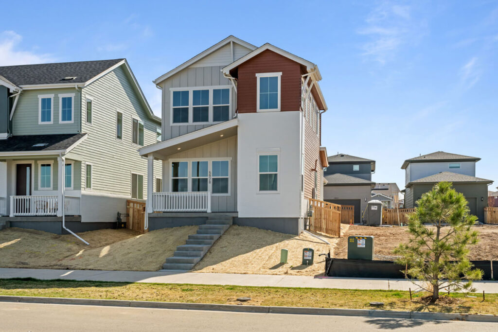 Beige and red quick move in home in Painted Prairie.