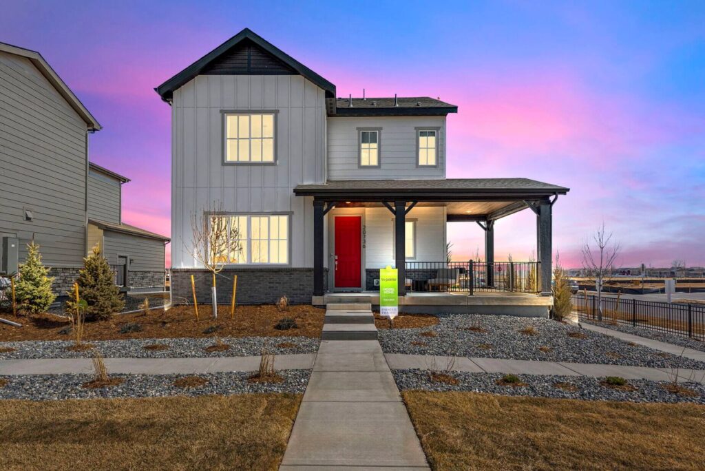 A new quick move-in home by Tri Pointe Homes at sunset with a pink and blue sky.